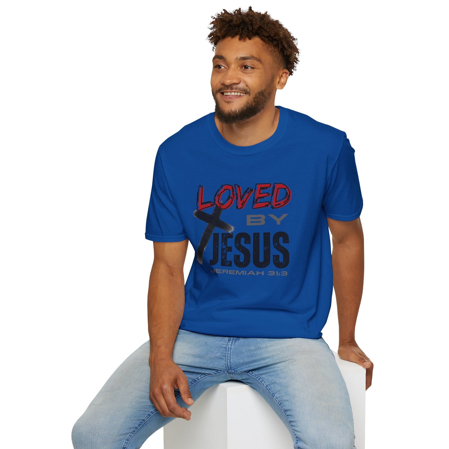 Royal Blue Christian graphic t-shirt with Loved by Jesus design worn by smiling man sitting