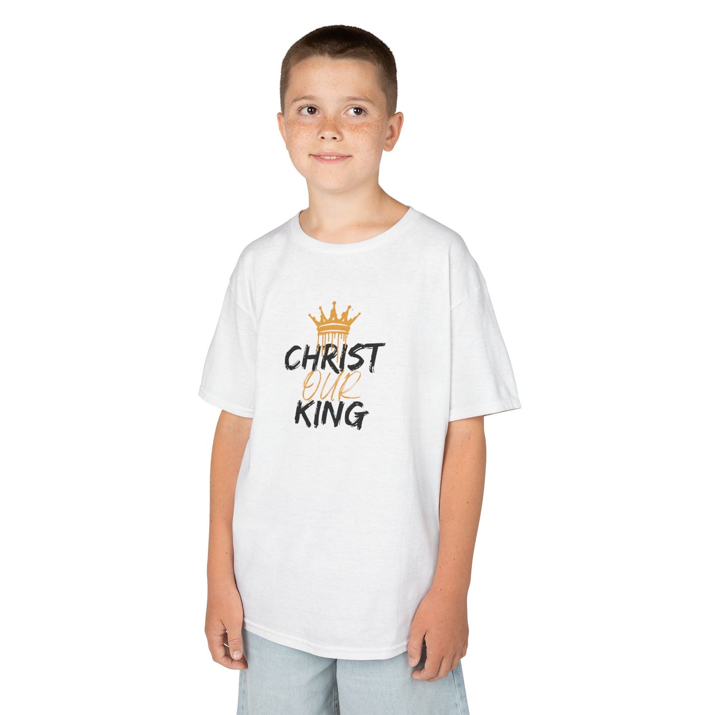 Christian junior kids t-shirt with Christ Our King print worn by a young boy in white tee and light shorts
