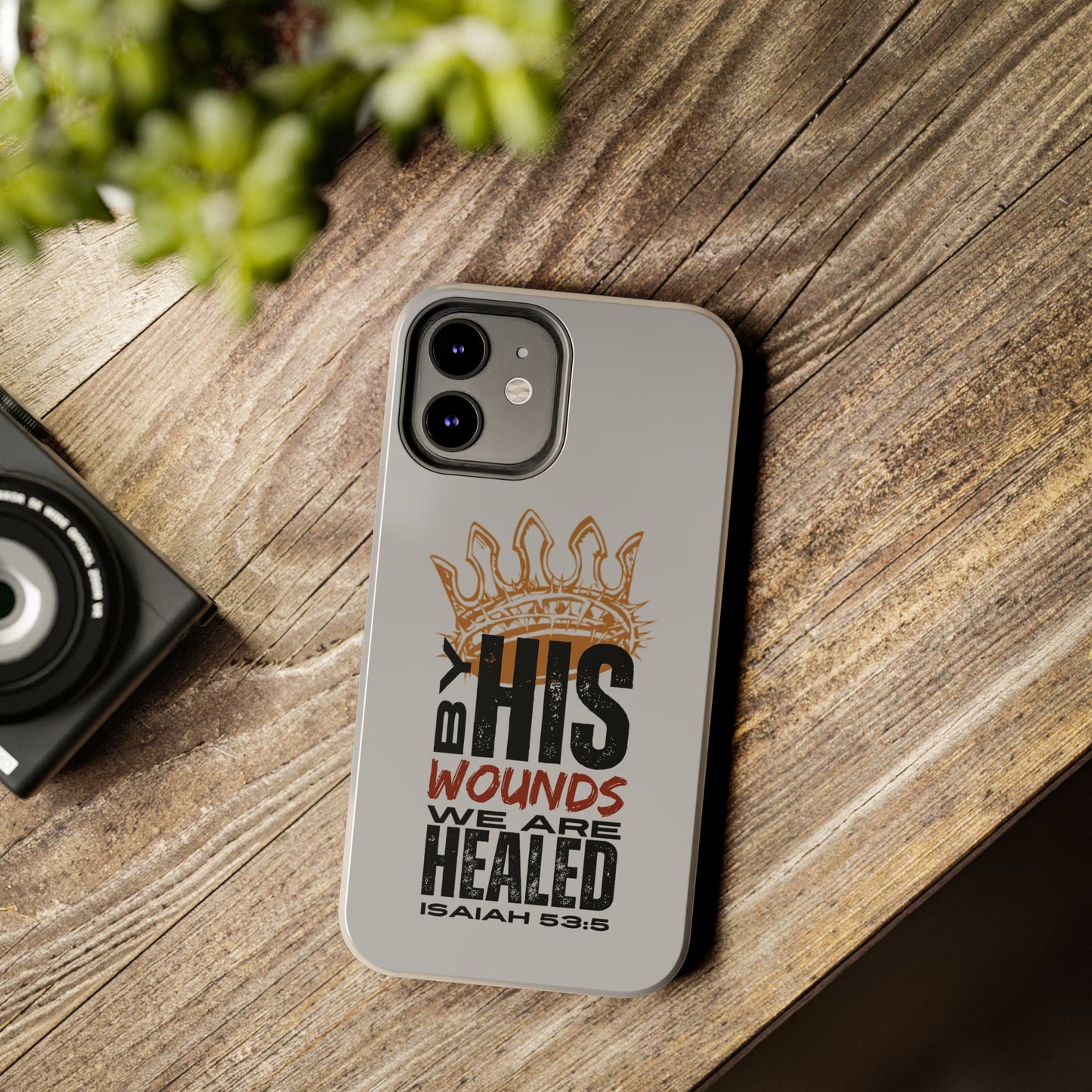 Logos gray scripture phone cover with Isaiah 53:5 design and protective fit on wooden surface