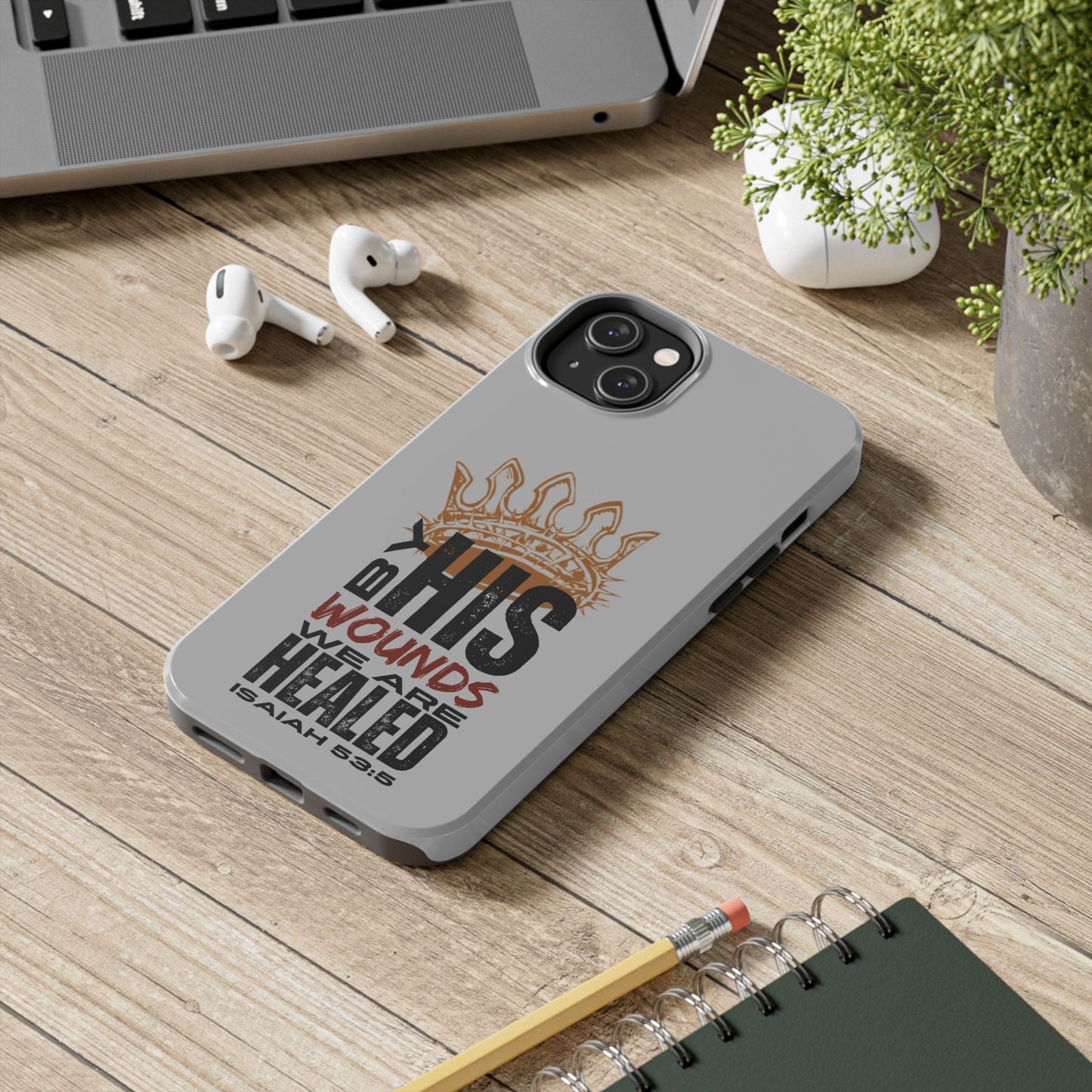 Logos gray scripture phone cover with Isaiah 63:5 Bible verse and crown design on wooden desk