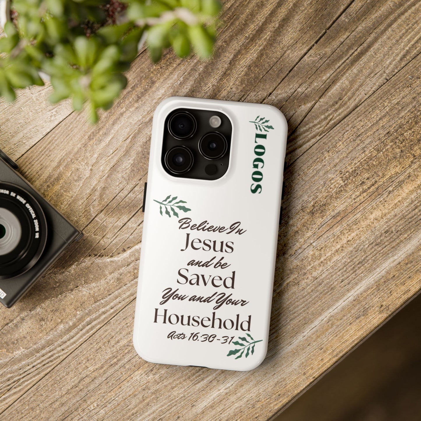 White Bible verse phone case by Logos with inspirational Acts 16:30-31 scripture design and logo on wooden table