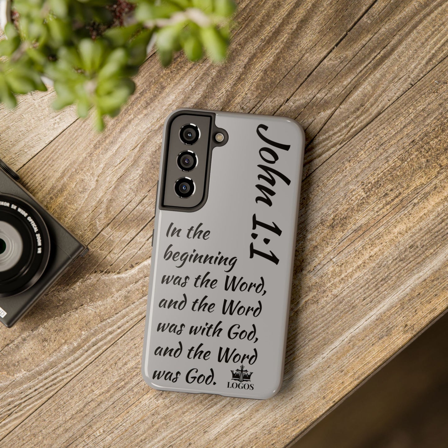 Bible verse phone case with John 1:1 scripture text on a gray Samsung phone cover