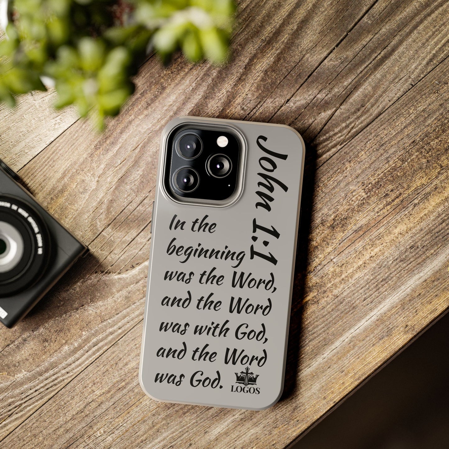 Logos Bible verse phone case with John 1:1 scripture text on a gray protective cover for iPhone with triple camera