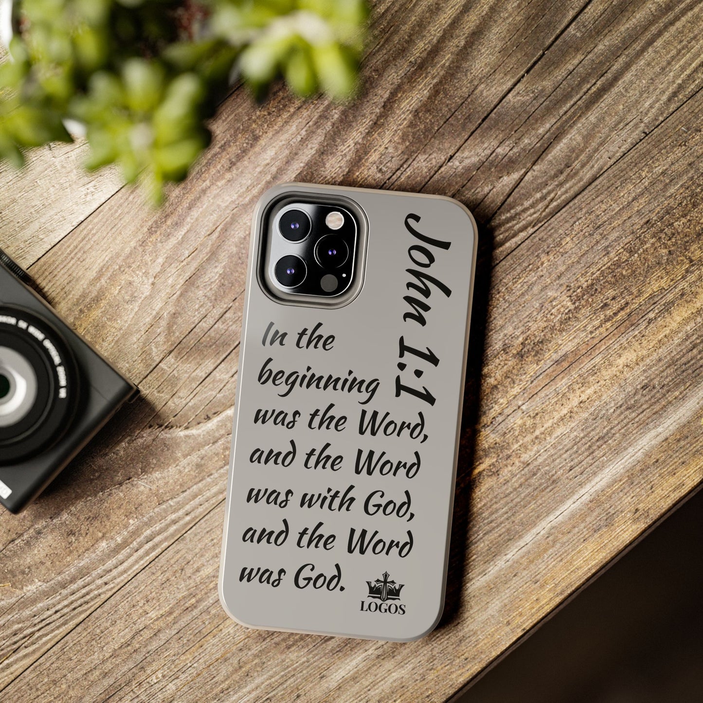 Bible verse phone case with John 1:1 scripture design by Logos on a wooden table