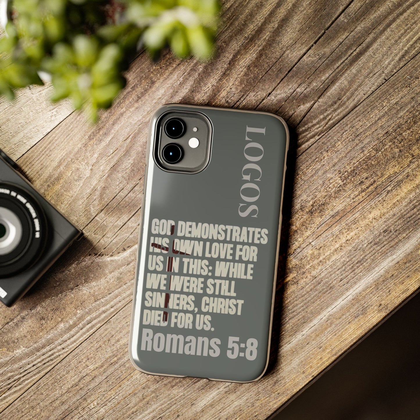 Christian phone case by Logos with Romans 5:8 scripture design in gray tones