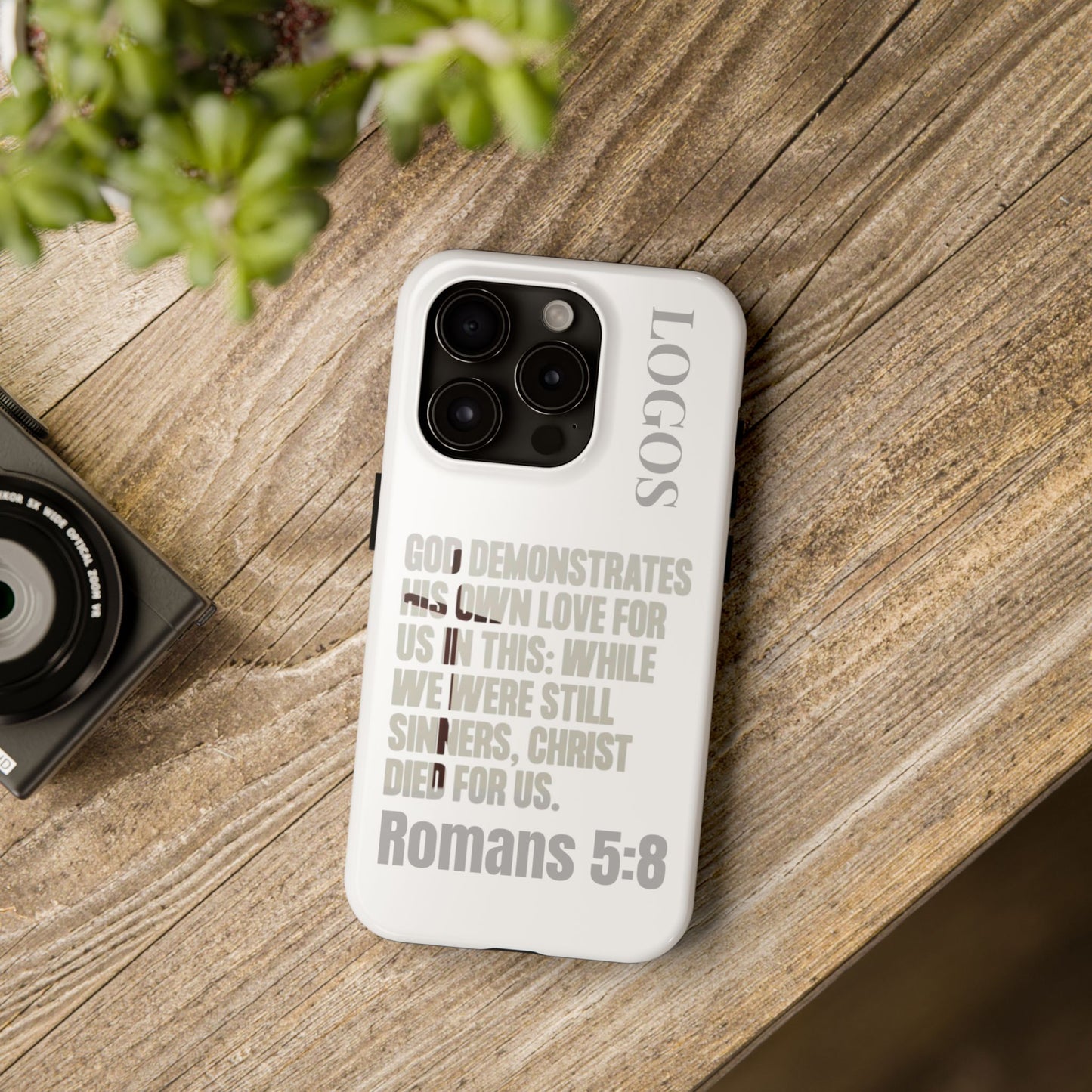 Logos Co. faith-based tough cases with Romans 5:8 scripture on white phone case featuring protective design