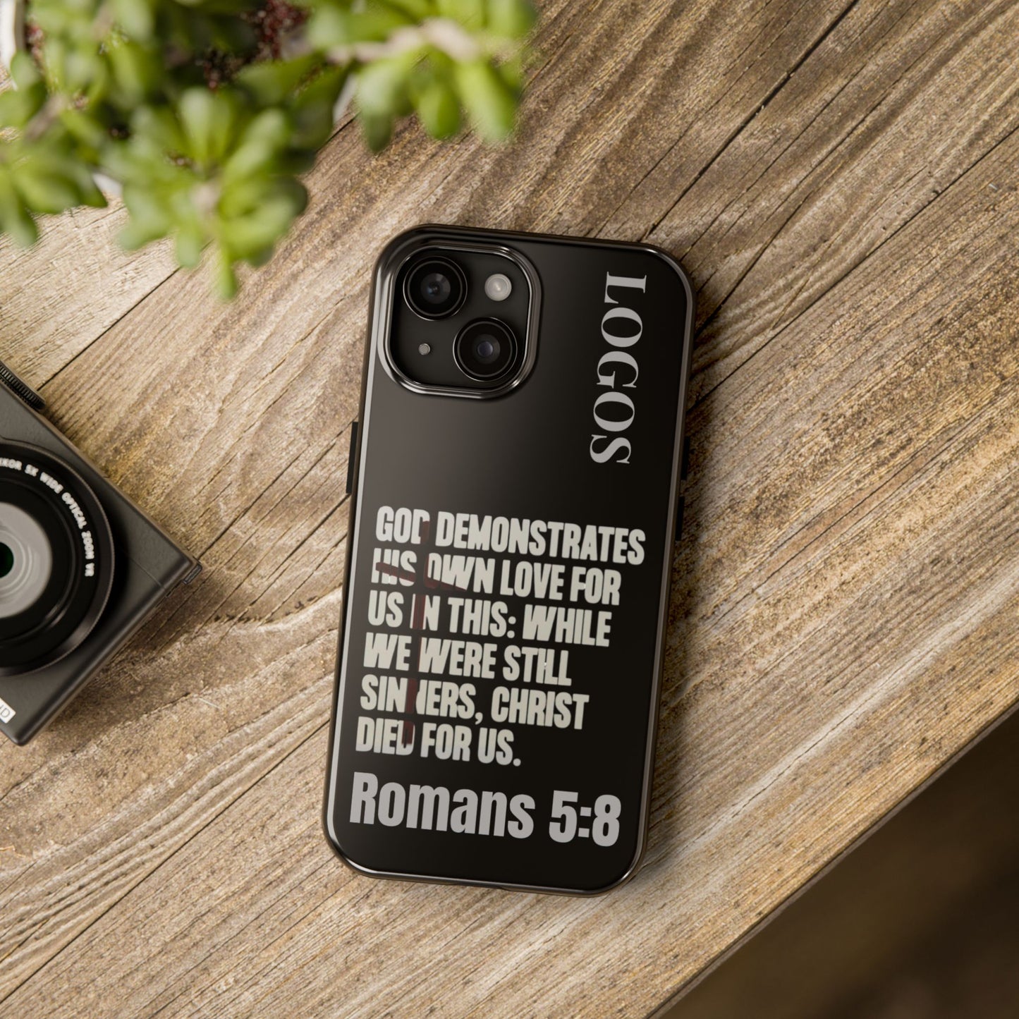 Logos Romans 5:8 phone case with black background and white religious text design