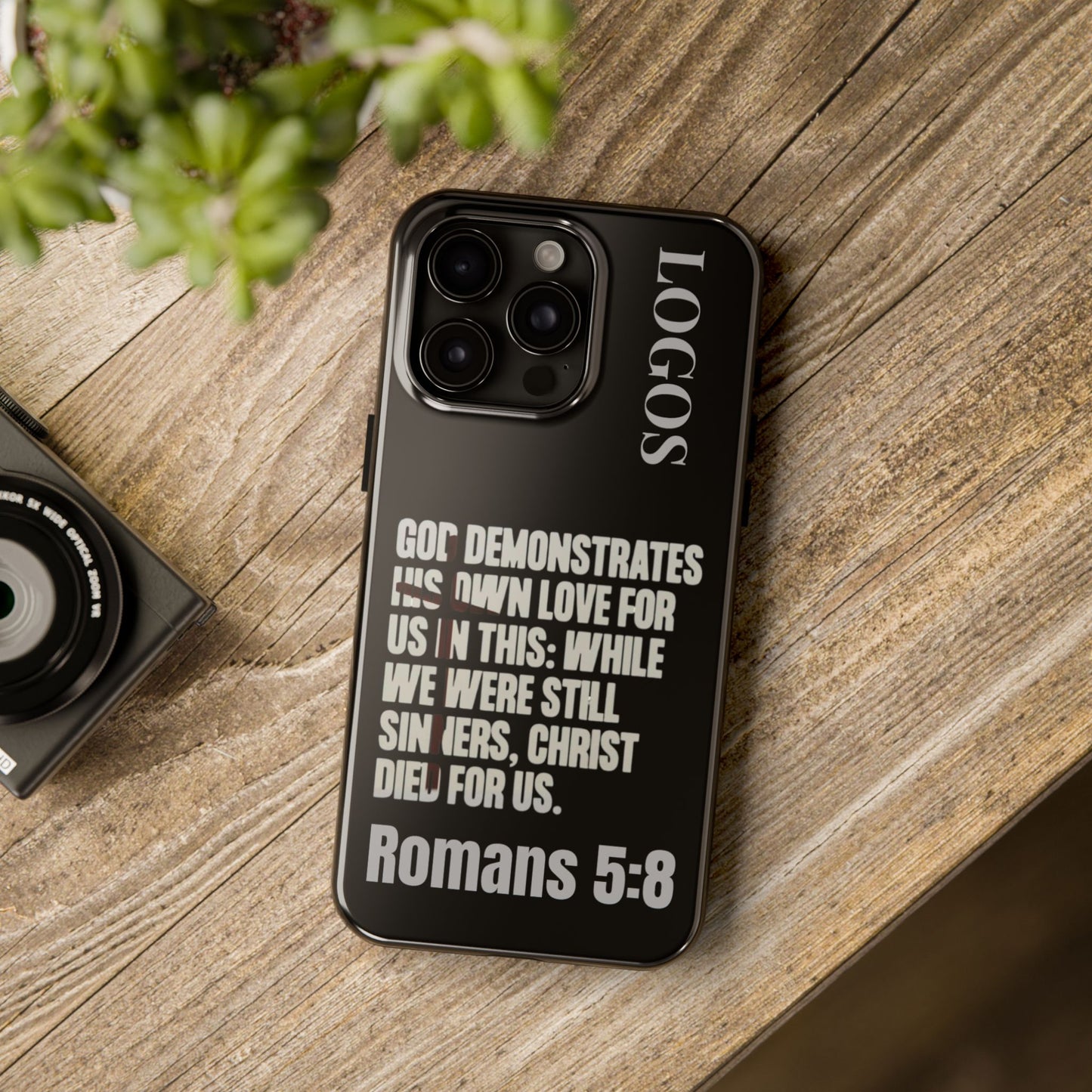 Logos Romans 5:8 phone case with black background and white inspirational Bible verse design
