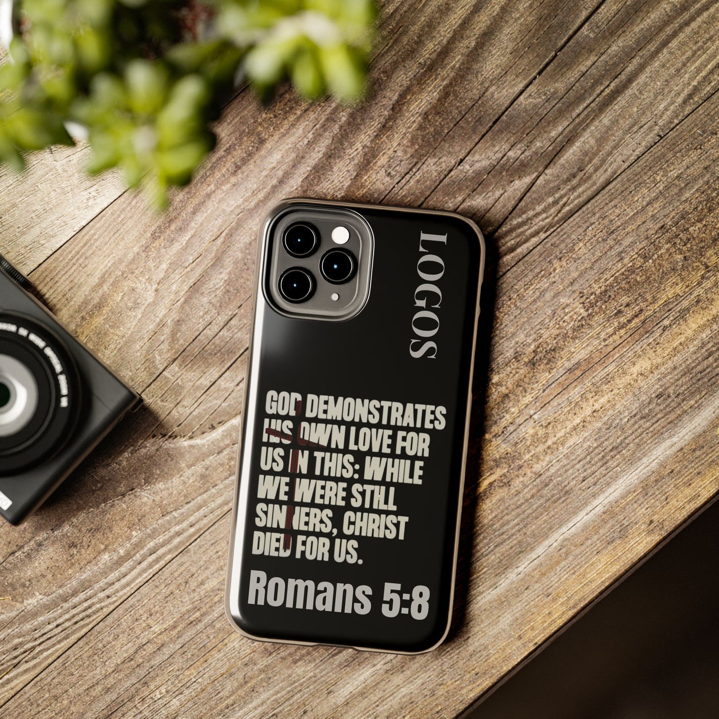 Logos Romans 5:8 phone case with black background and white biblical text design for iPhone