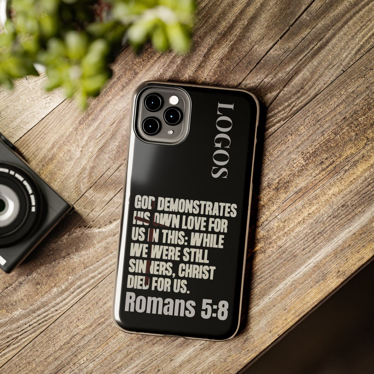 Logos Romans 5:8 phone case with black background and inspirational Bible verse design