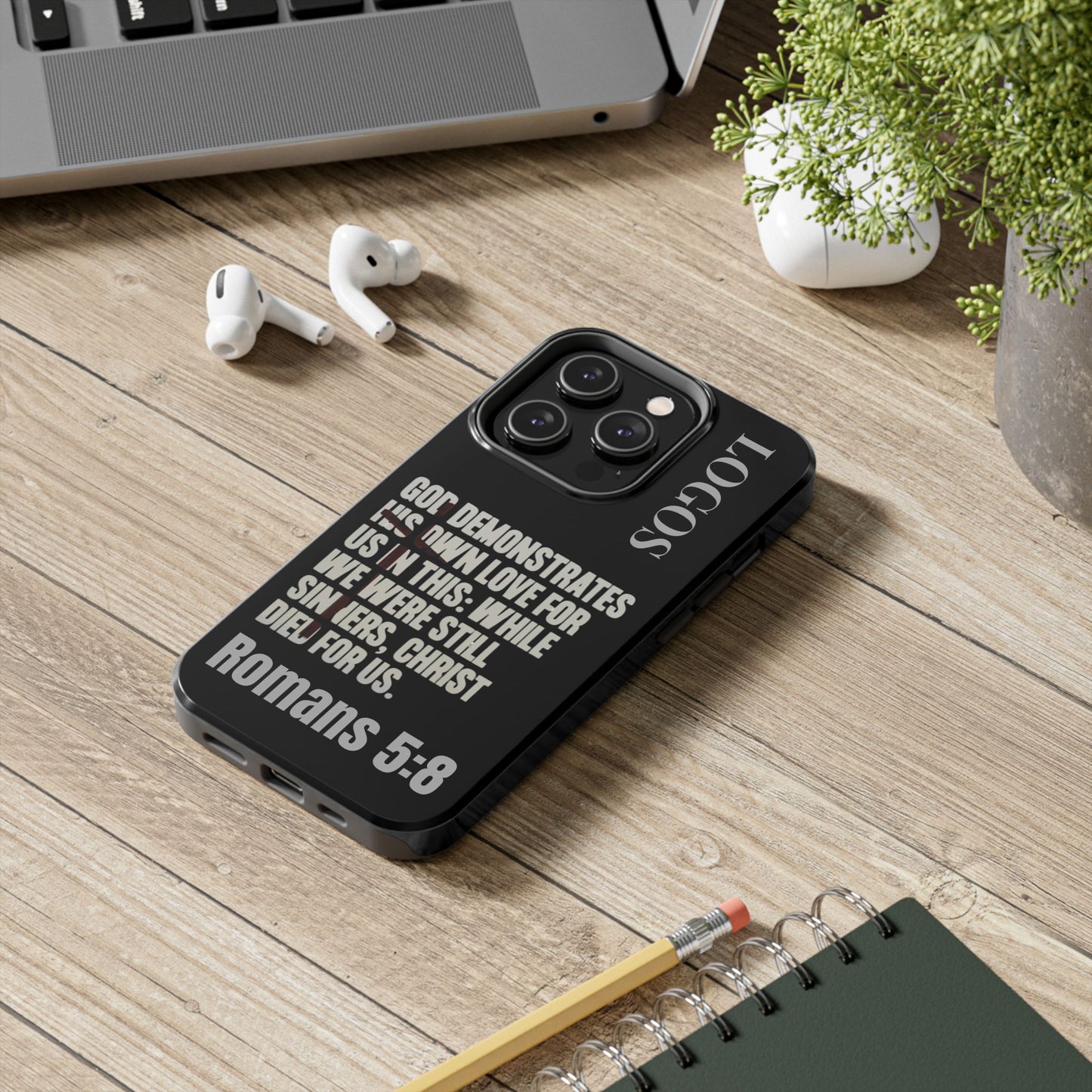 Romans 5:8 phone case with inspirational Bible verse printed on black protective cover from Logos