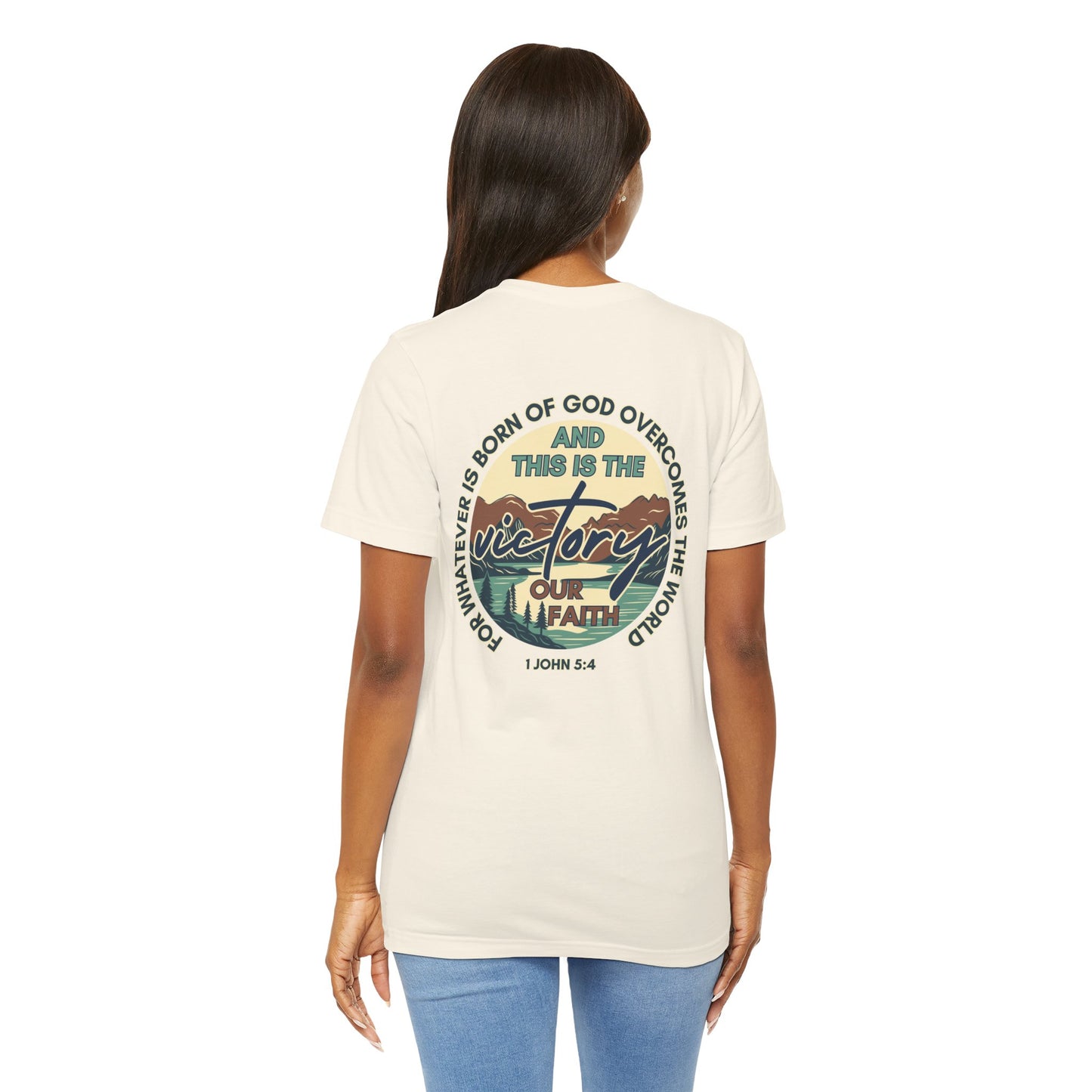 Back view of a woman wearing a Logos Co. This Is The Victory T-shirt with faith-themed graphic design