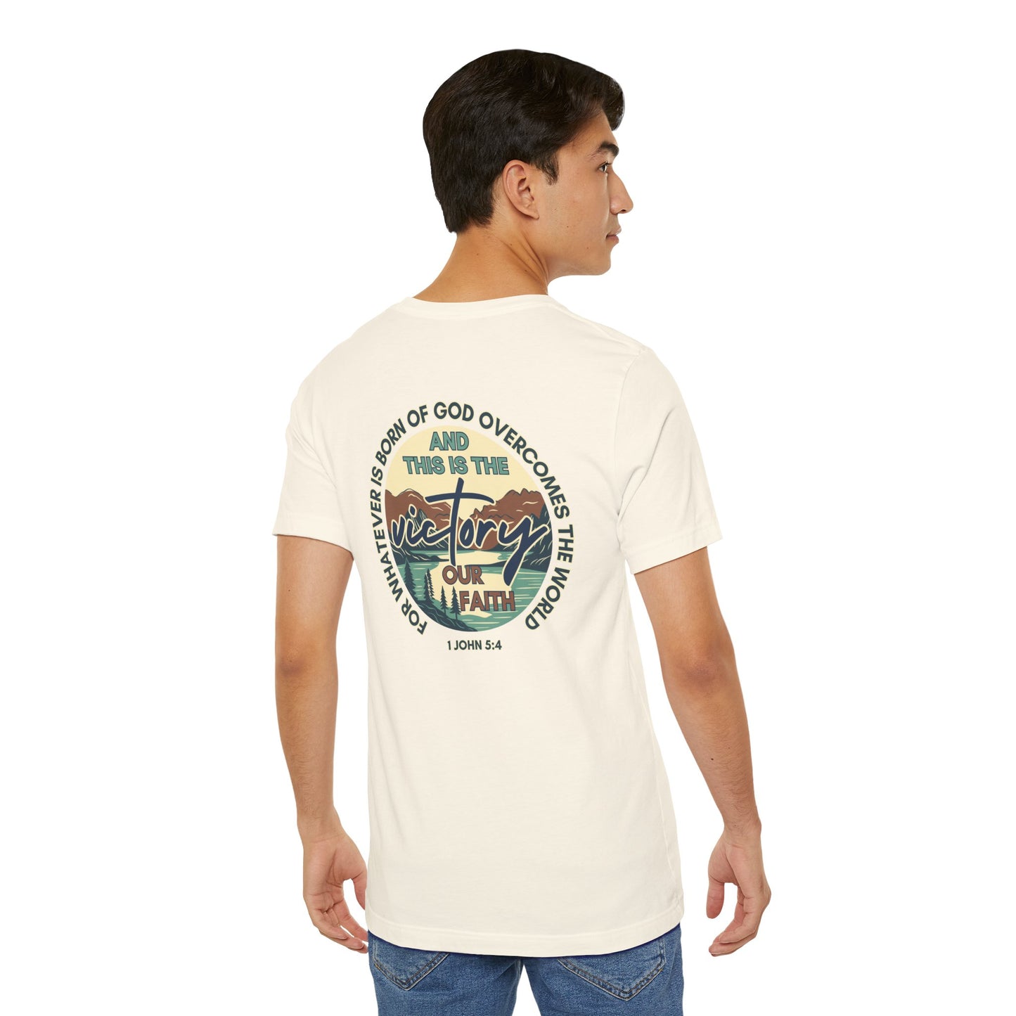 Logos This Is The Victory T-shirt cream color with faith-inspired graphic design on back worn by male model