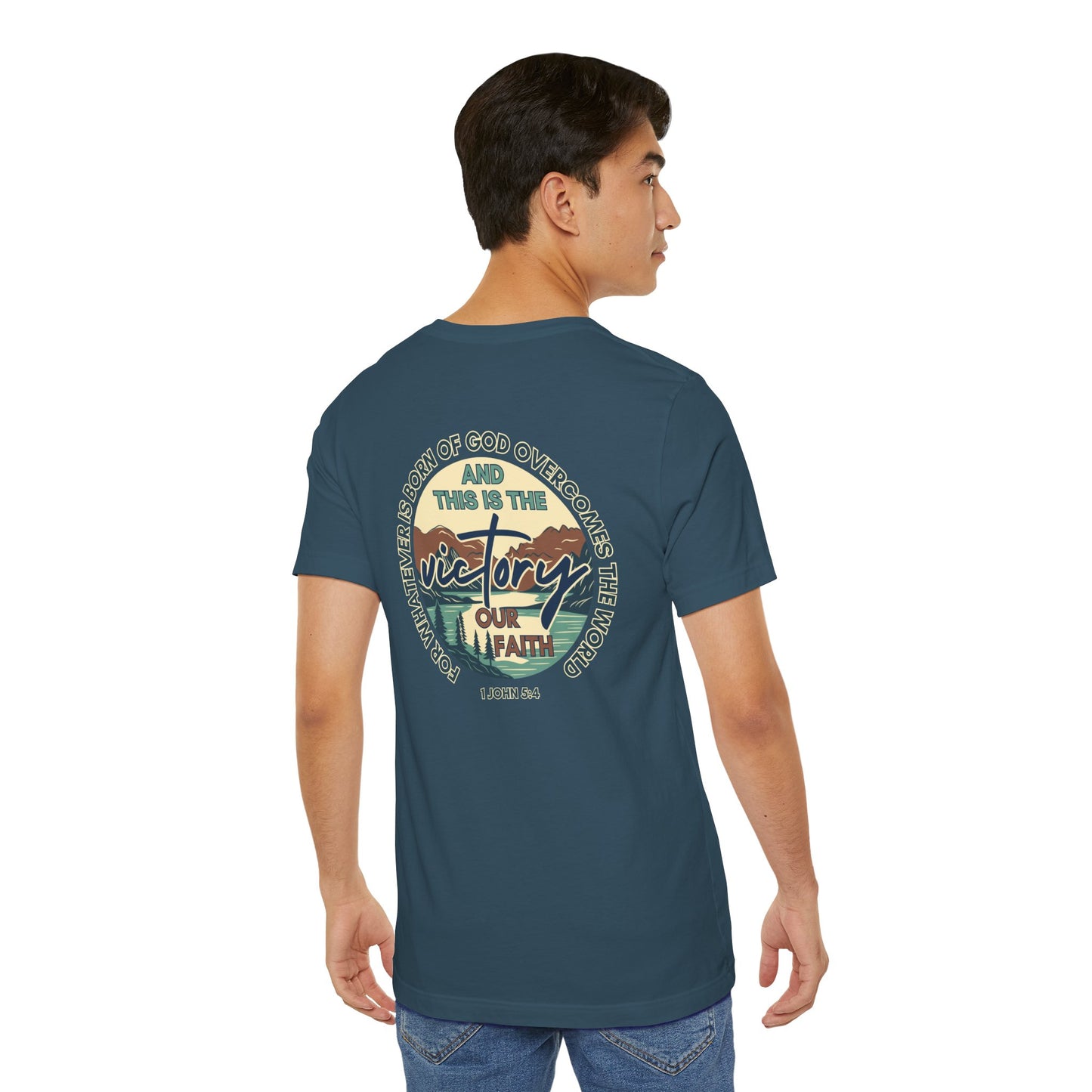 Back view of a man wearing a blue This Is The Victory T-shirt with faith and victory graphic
