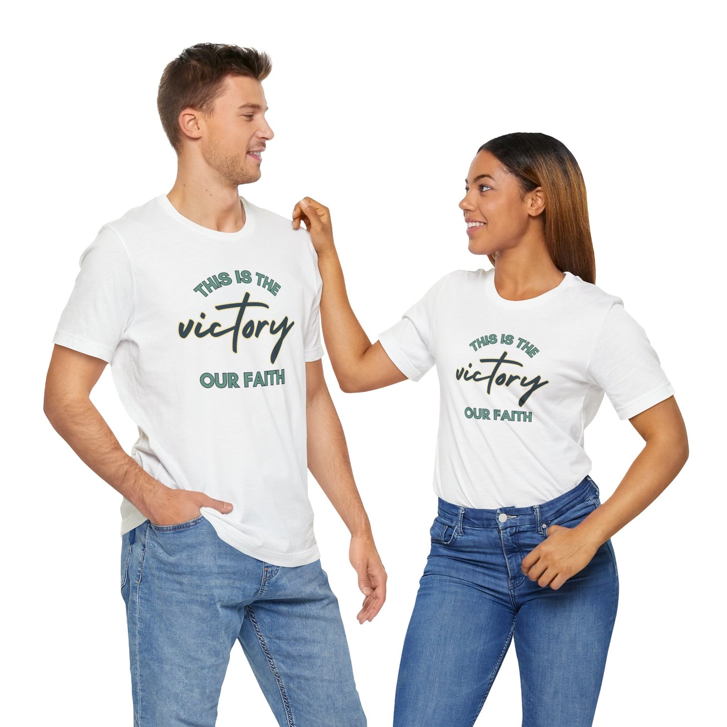 Man and woman wearing white This Is The Victory T-shirt with faith message and casual jeans