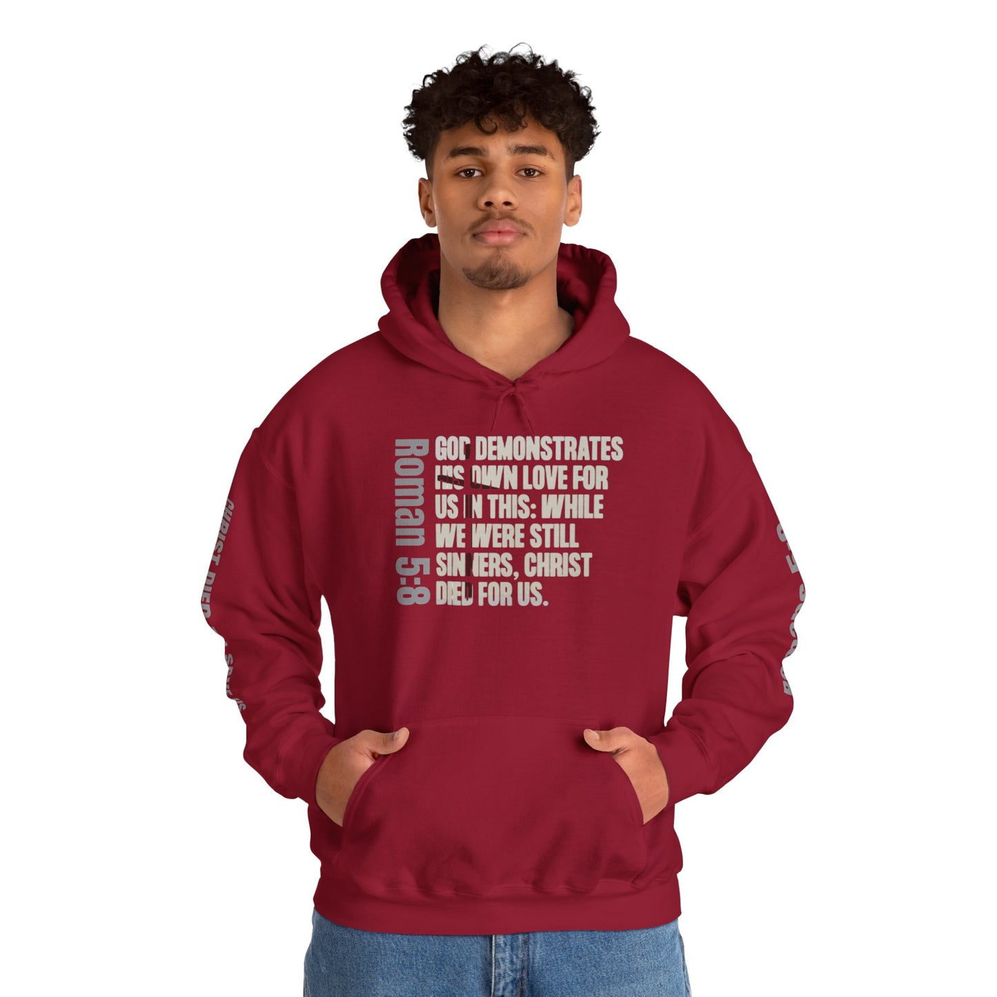Cardinal Red Romans 5:8 faith hoodie with biblical text design worn by male model