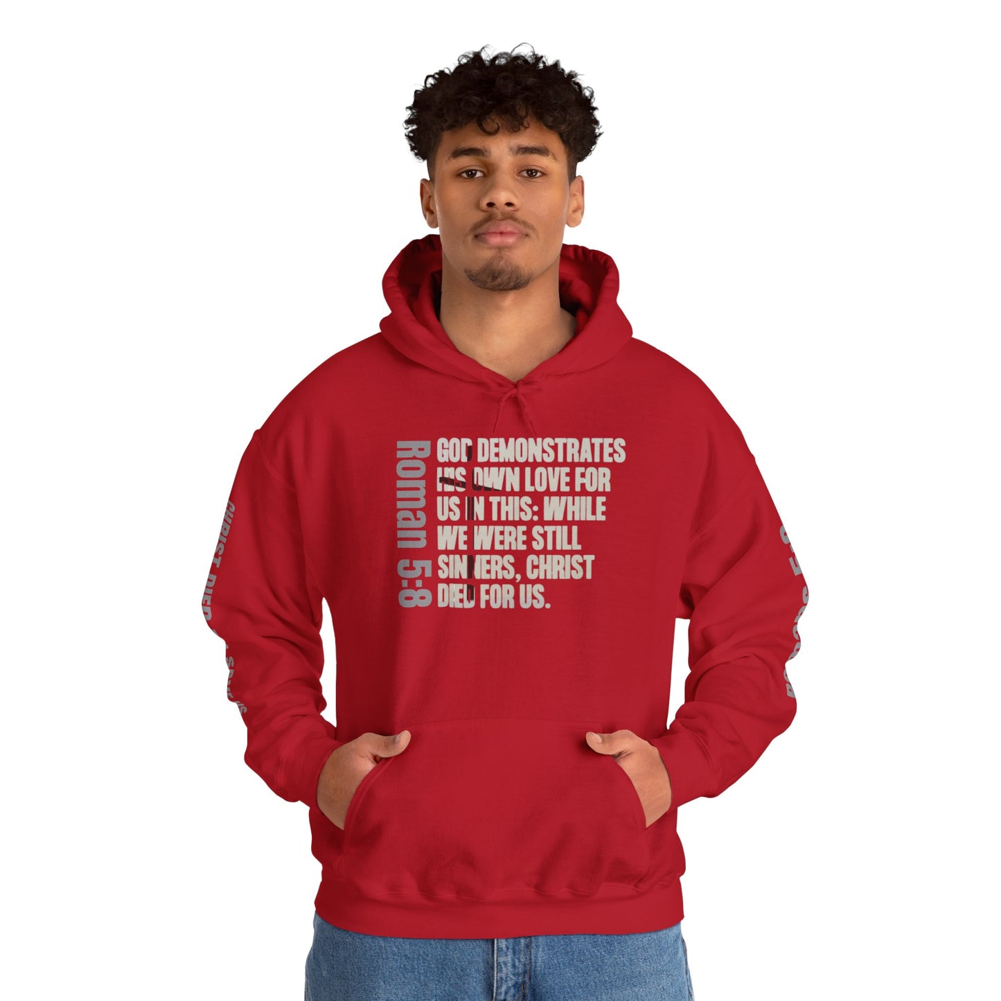 Romans 5:8 faith hoodie in red with inspirational biblical text on front worn by man