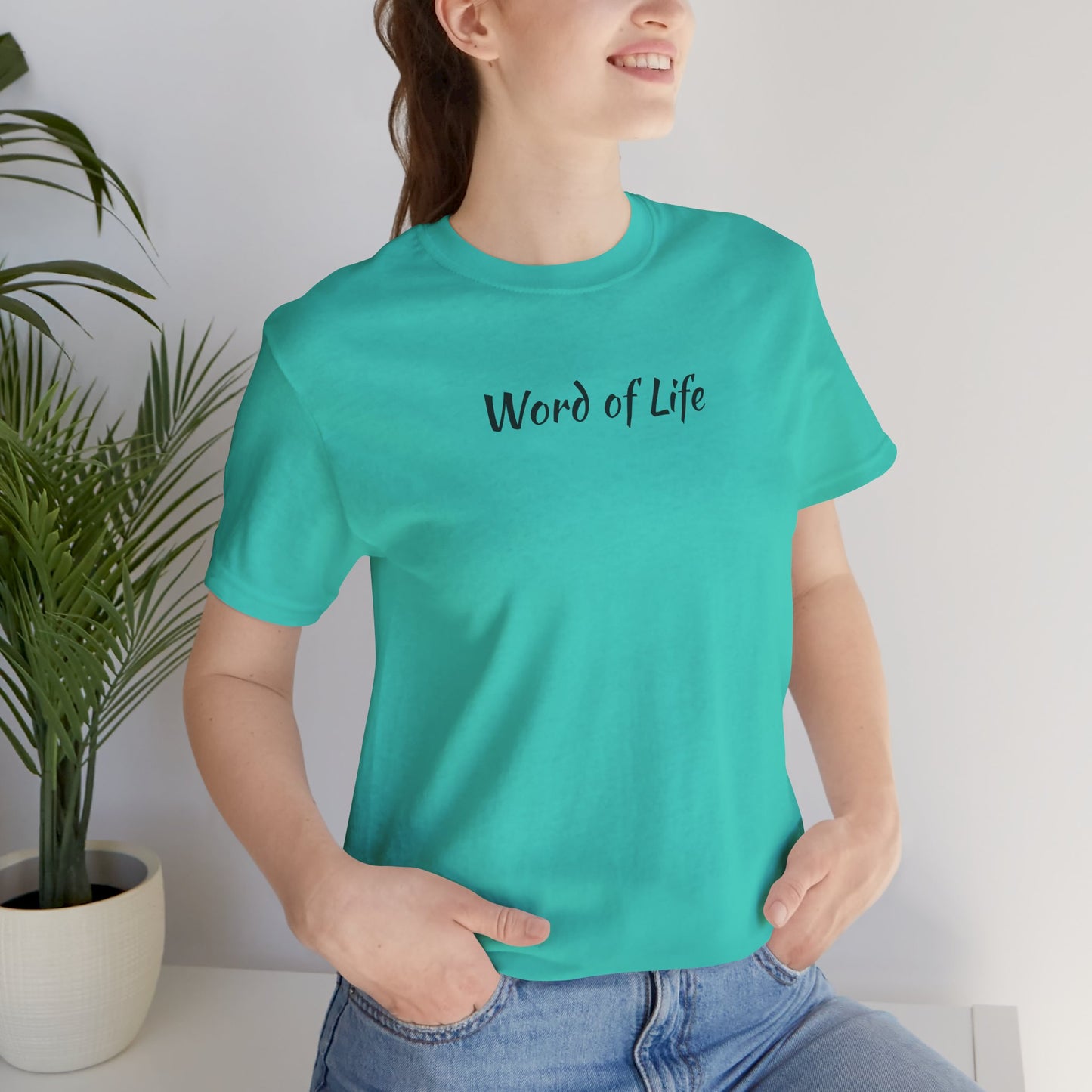Woman wearing turquoise Word of Life Christian shirt paired with blue jeans
