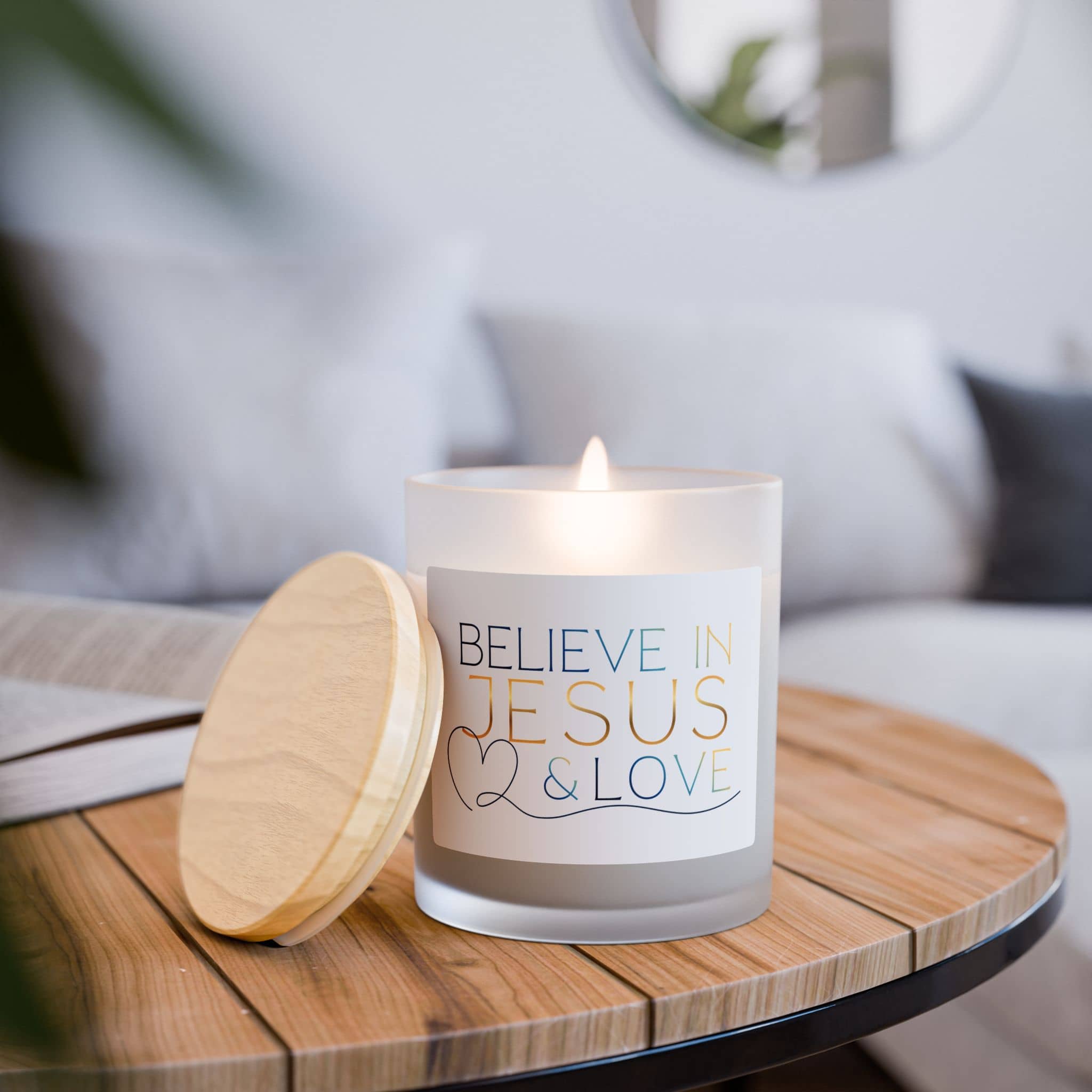 Frosted Glass Candle featuring 'Believe in Jesus & Love' design with a wooden lid, front view on a wooden table