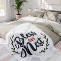 Bless Our Nest fleece blanket featuring elegant typography and leafy design for cozy home decor