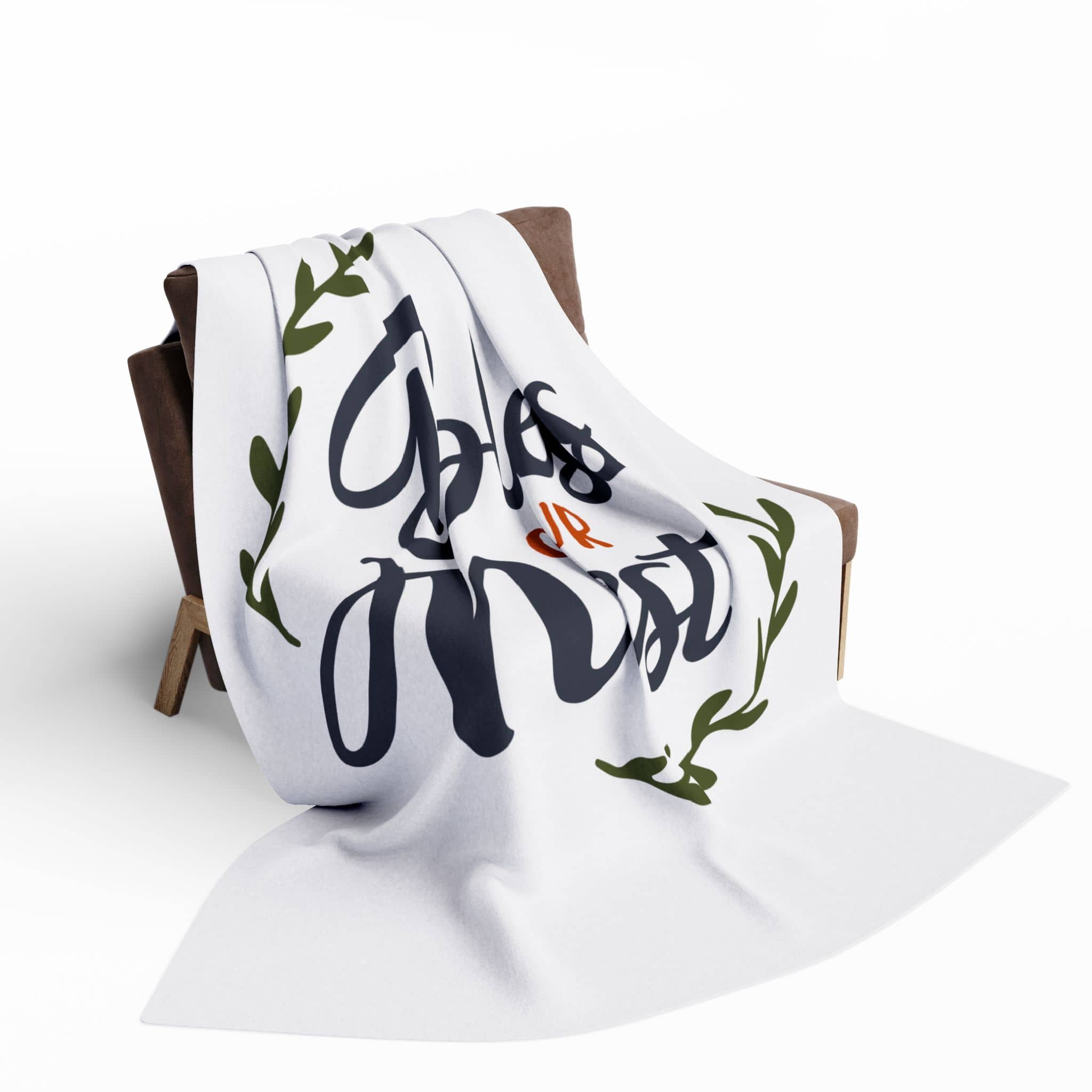 Bless Our Nest fleece blanket draped over a cozy armchair with a stylish design