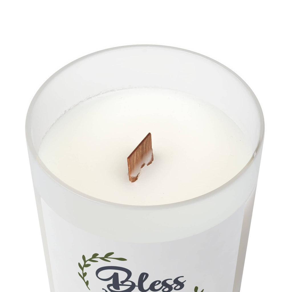Frosted glass candle with 'Bless Our Nest' phrase and wood wick, top view showcasing the white wax