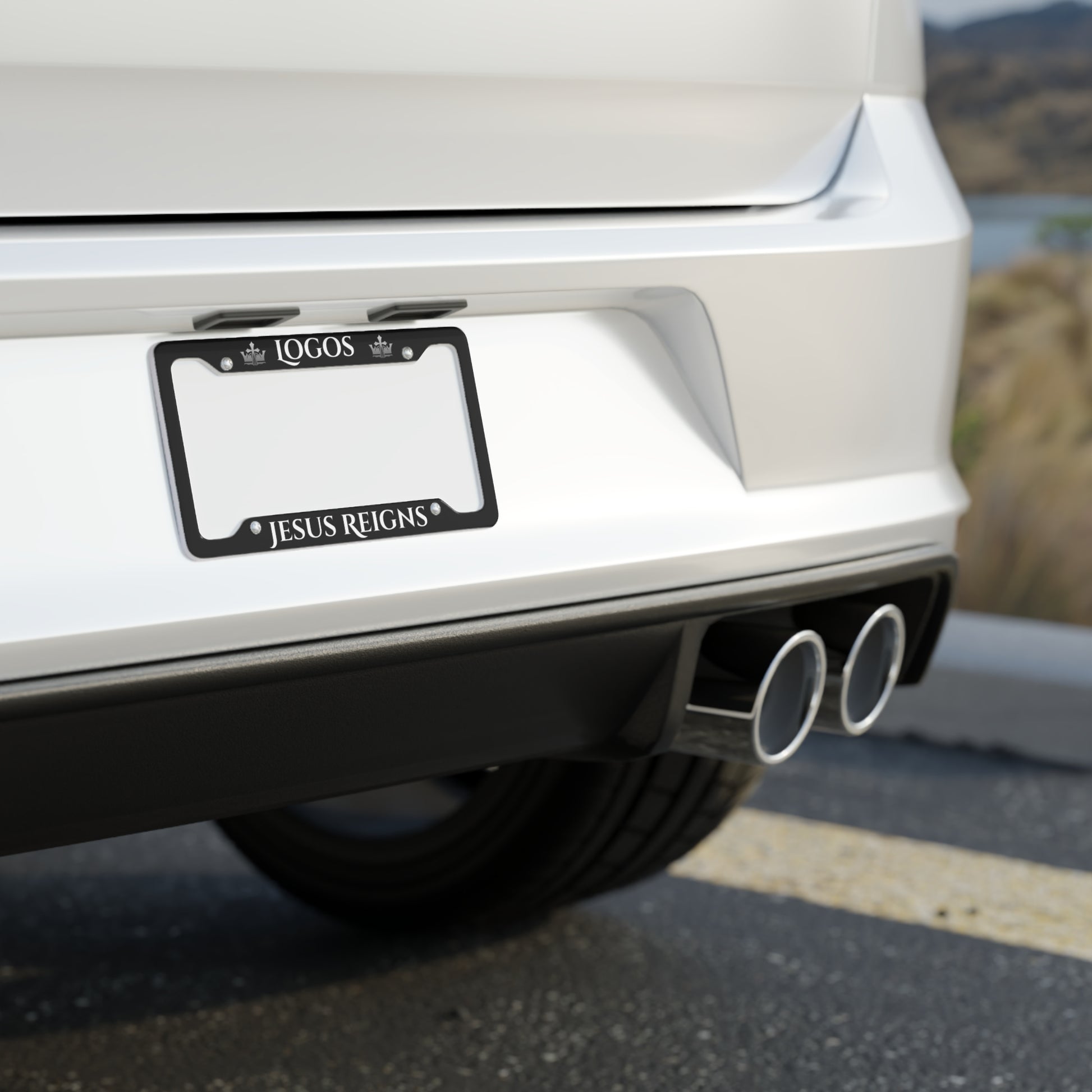 Jesus Reigns car accessory license plate frame mounted on a white vehicle rear