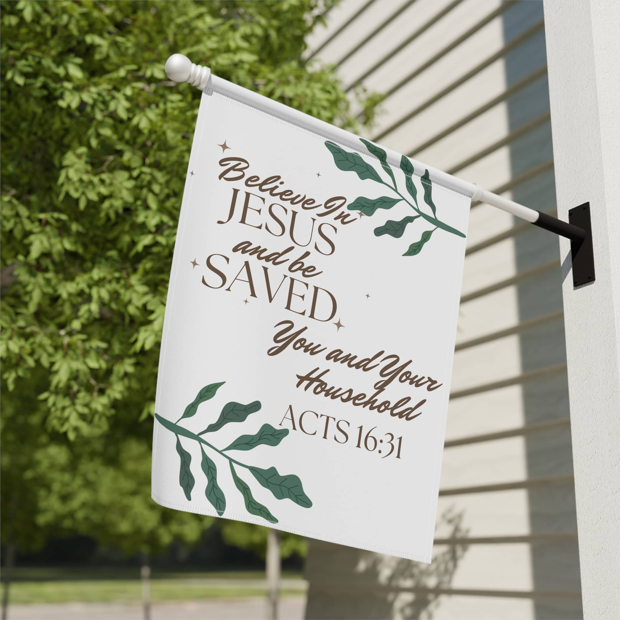 Christian house flags with Believe in Jesus and be saved quote hanging on porch pole