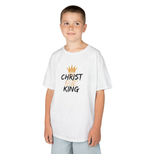 Christian junior kids t-shirt with Christ Our King print worn by a young boy in white tee and light shorts