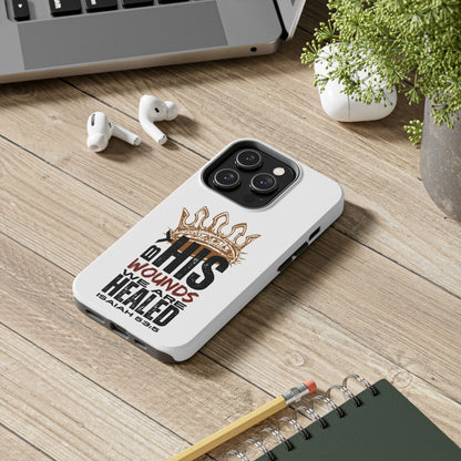 Logos Co. Christian tough phone case with IHS crown design and healing scripture on wood desk