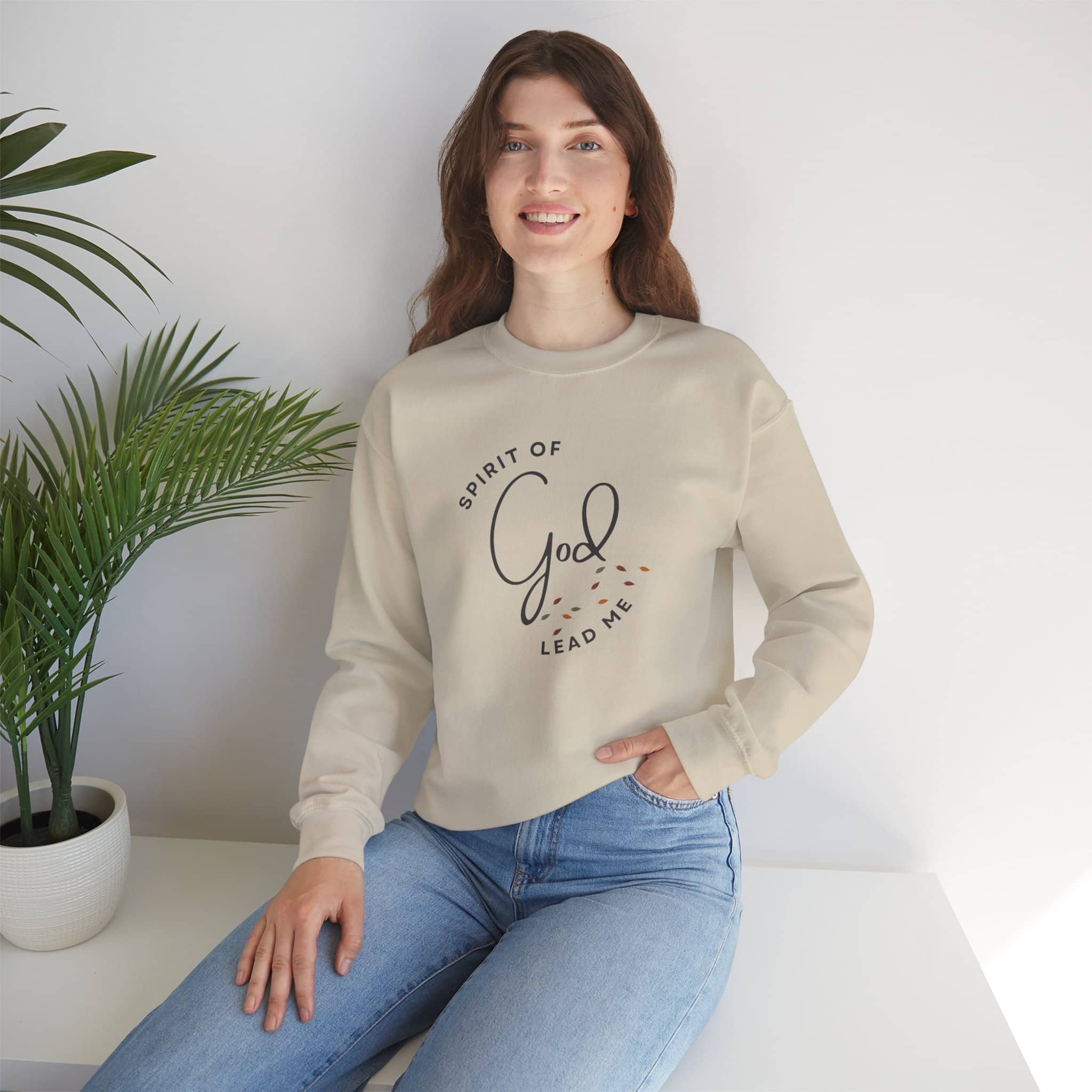 Logos beige Christian women's sweatshirt with Spirit of God Lead Me text worn by woman