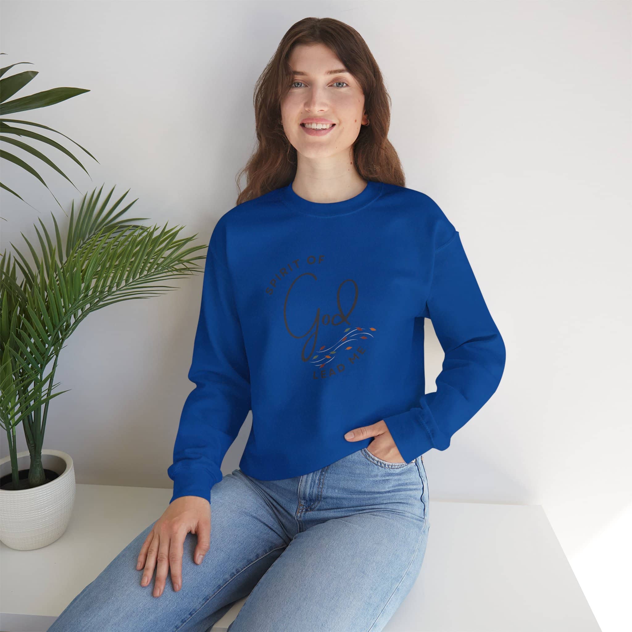 Logos women's sweatshirt in blue with Spirit of God Lead Me design worn by a woman