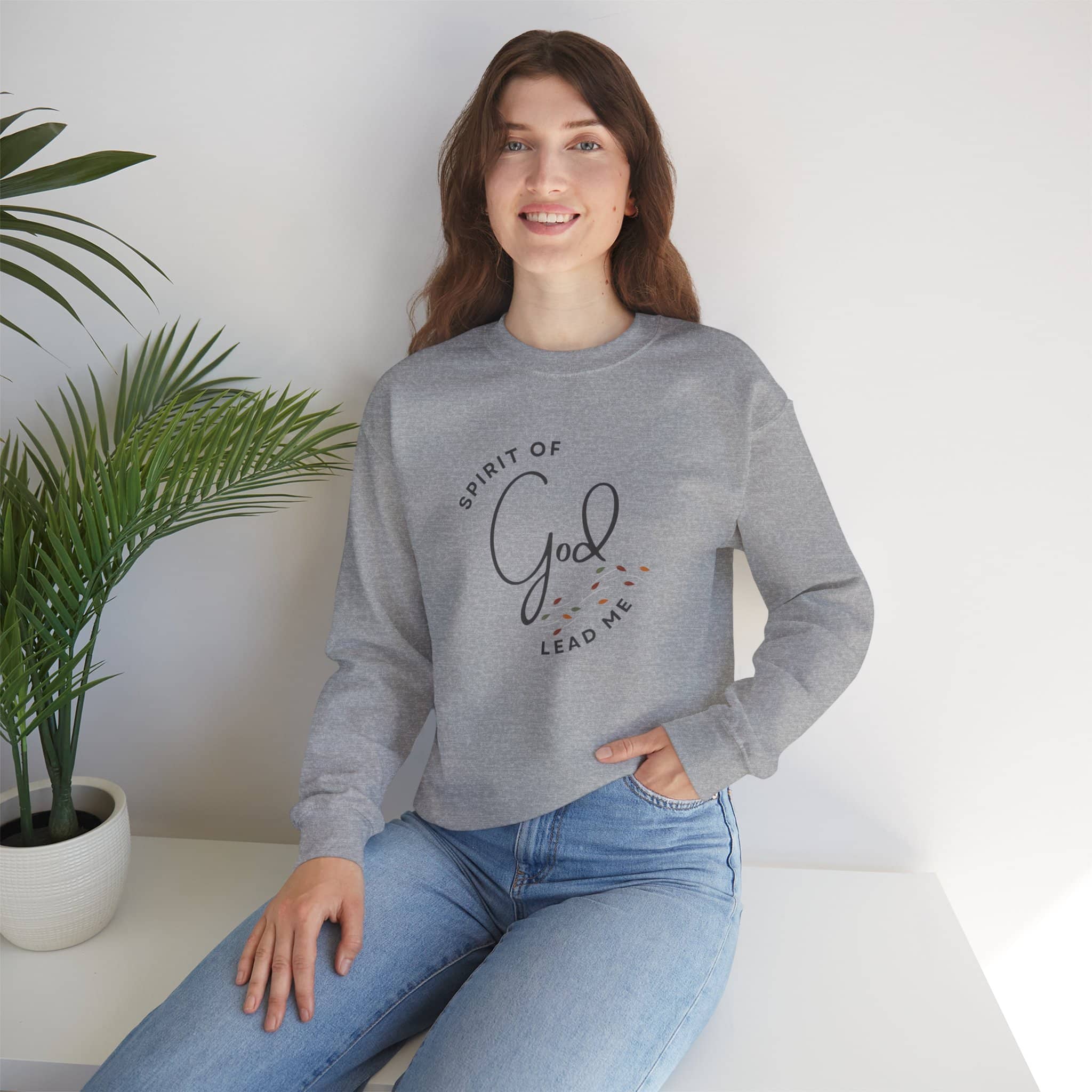 Christian women's sweatshirt in gray with 'Spirit of God Lead Me' text worn by woman