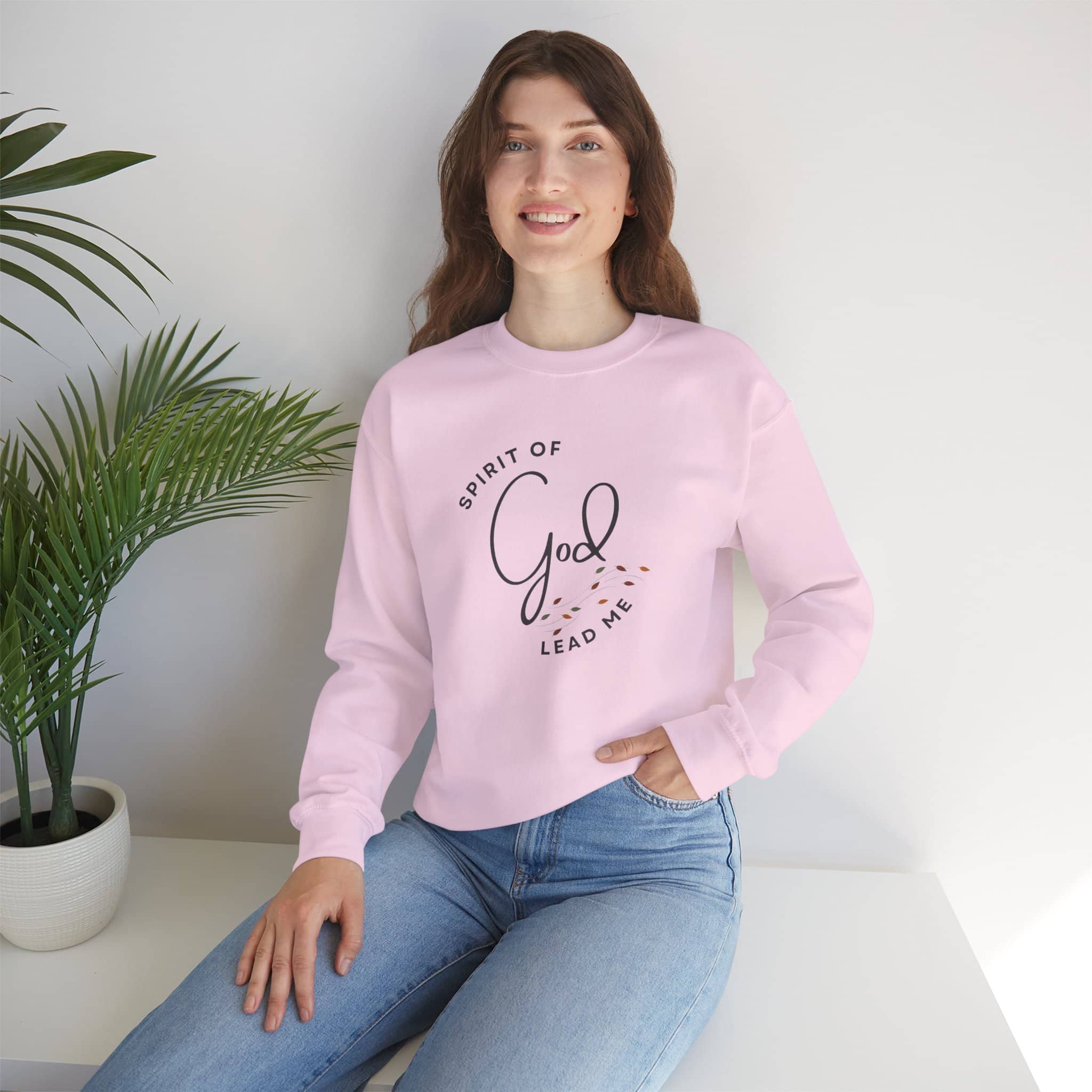 Logos pink Christian women's sweatshirt with Spirit of God Lead Me design worn by smiling woman