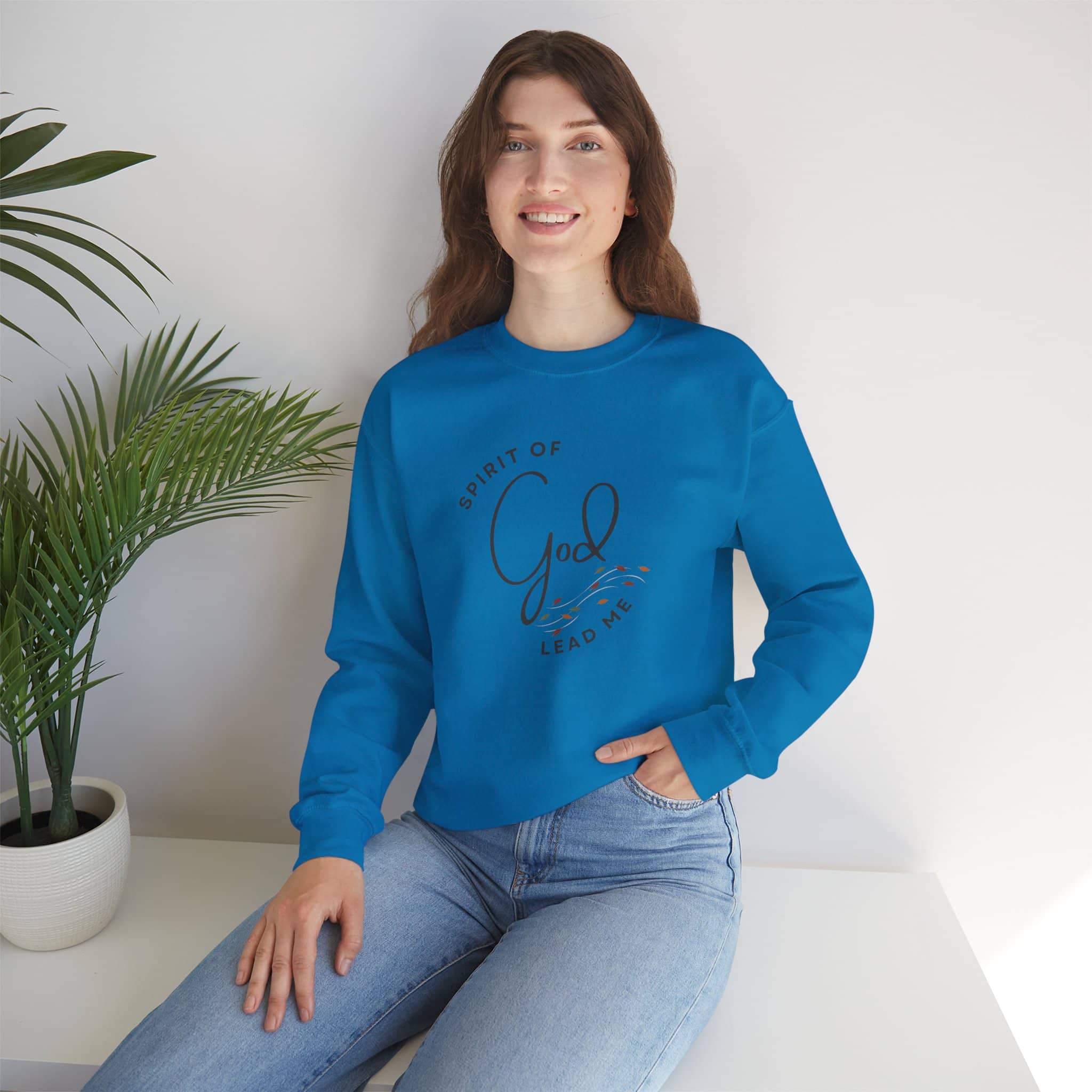 Logos blue Christian women's sweatshirt with Spirit of God lead me design worn by smiling woman