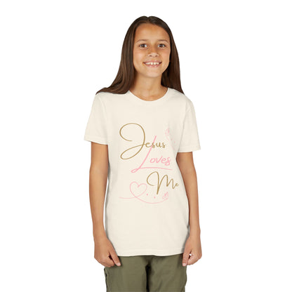 Jesus Loves Me youth shirt on smiling girl in cream tee with pink gold script design by Logos Co.