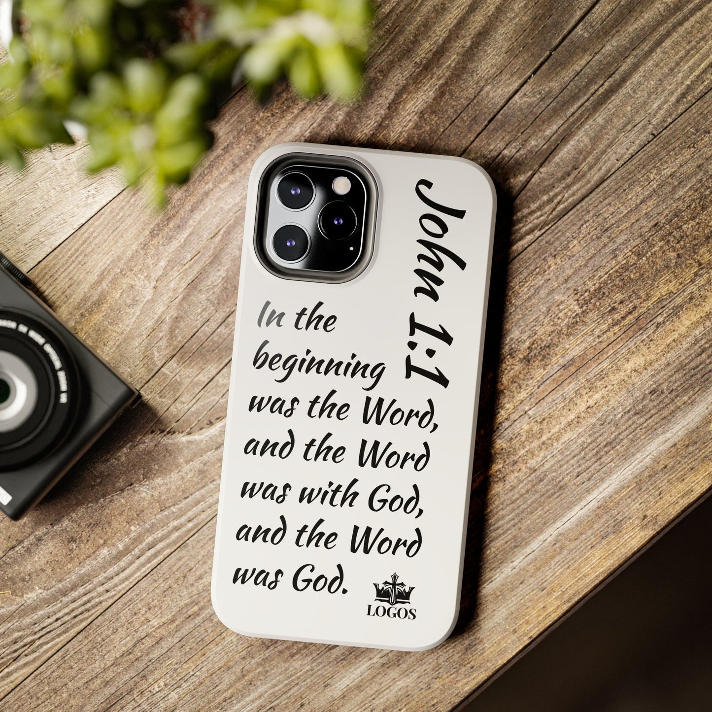 Faith-based tough phone case featuring John 1:1 verse design on a wooden surface