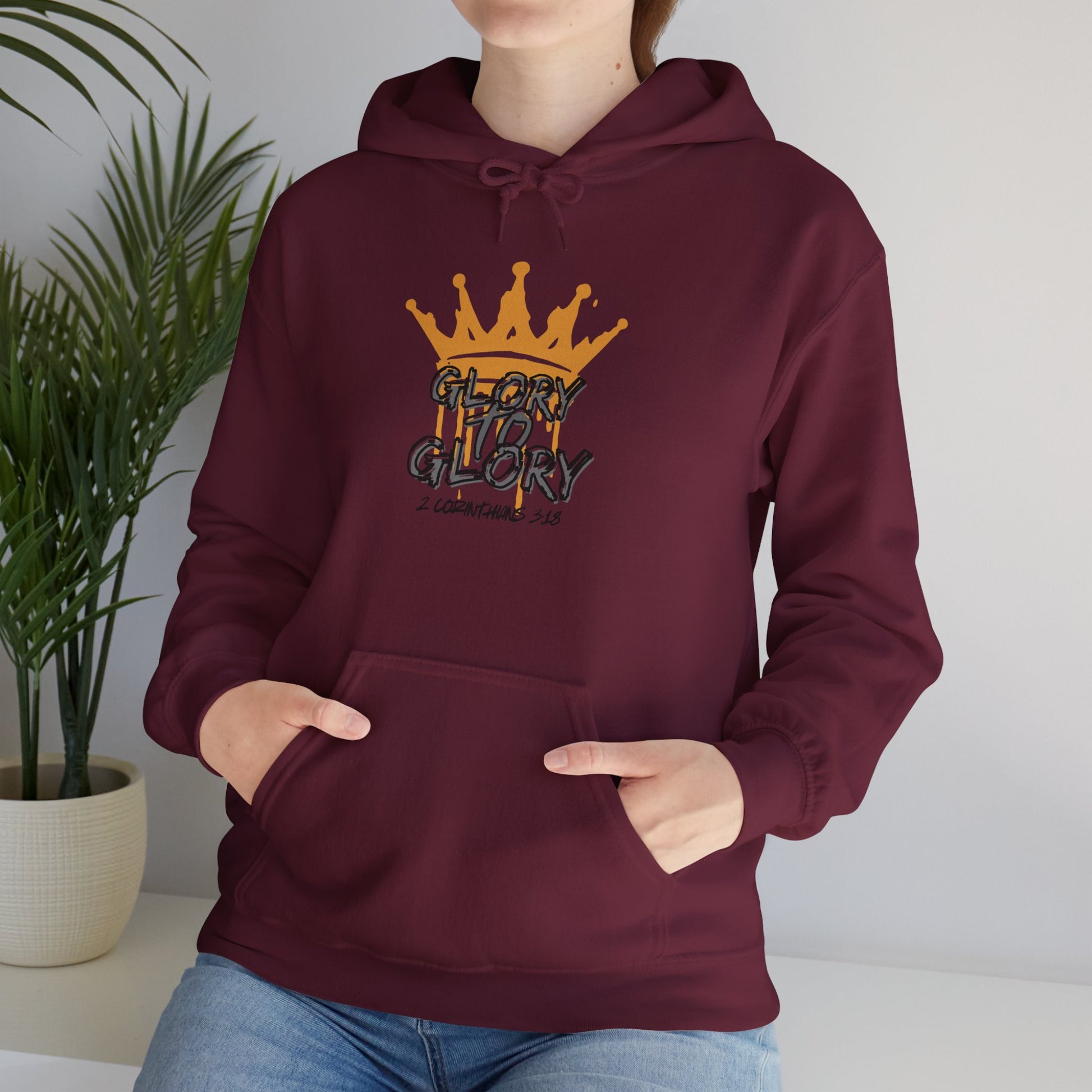 Maroon Glory to Glory hoodie with crown graphic worn by person sitting indoors