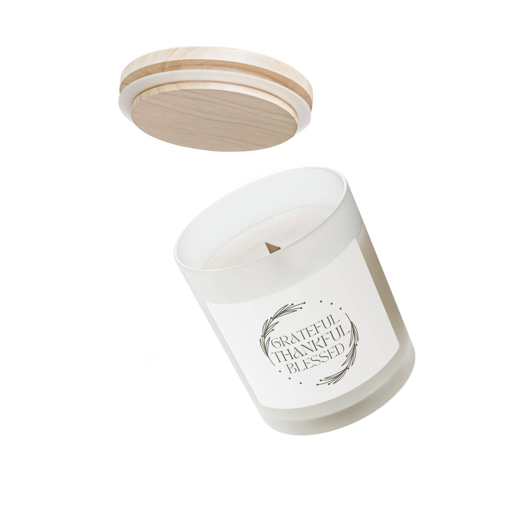 Scented candle with Grateful, Thankful, Blessed phrase in white glass and wooden lid, shown from the front