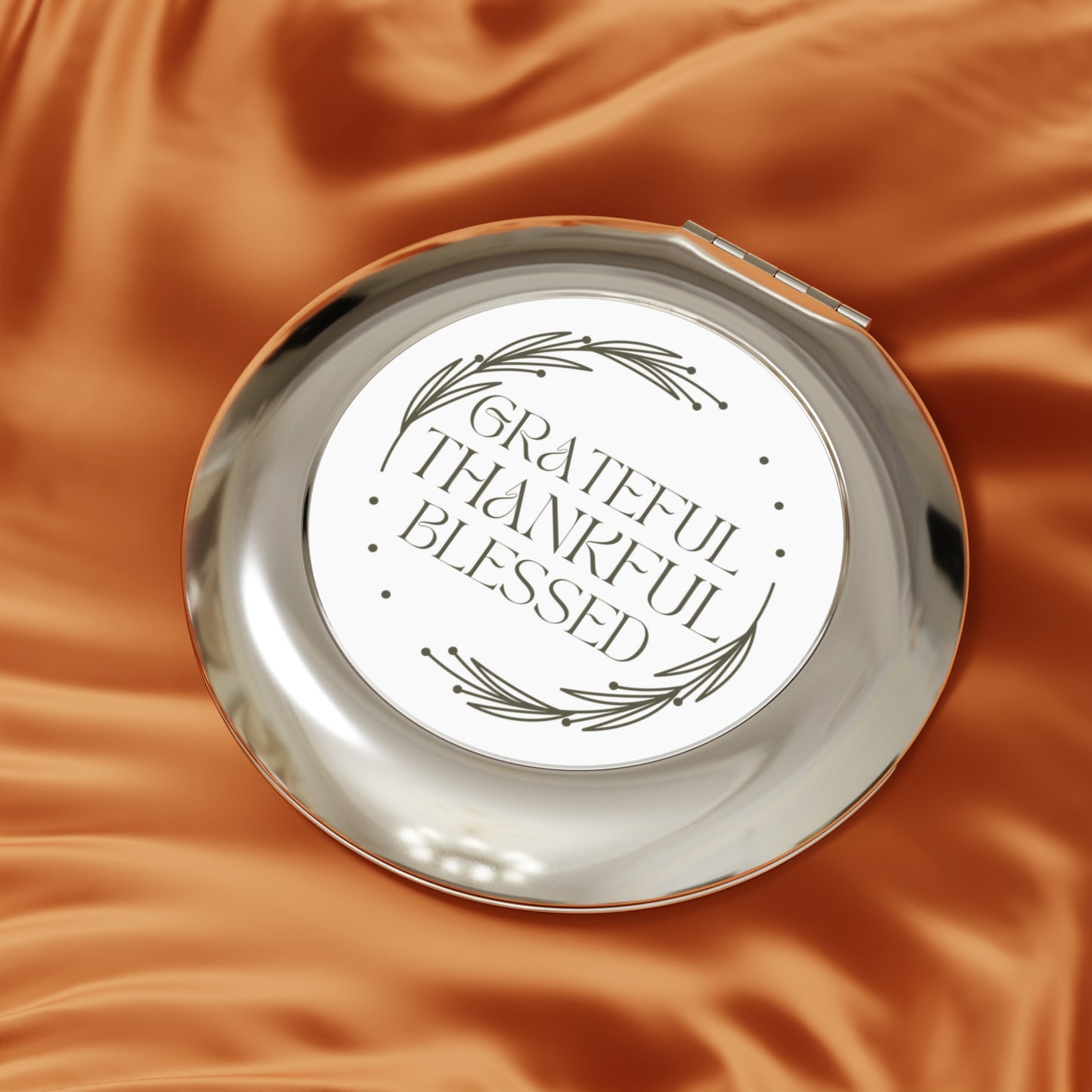 Grateful Thankful Blessed compact mirror with elegant design on a smooth surface