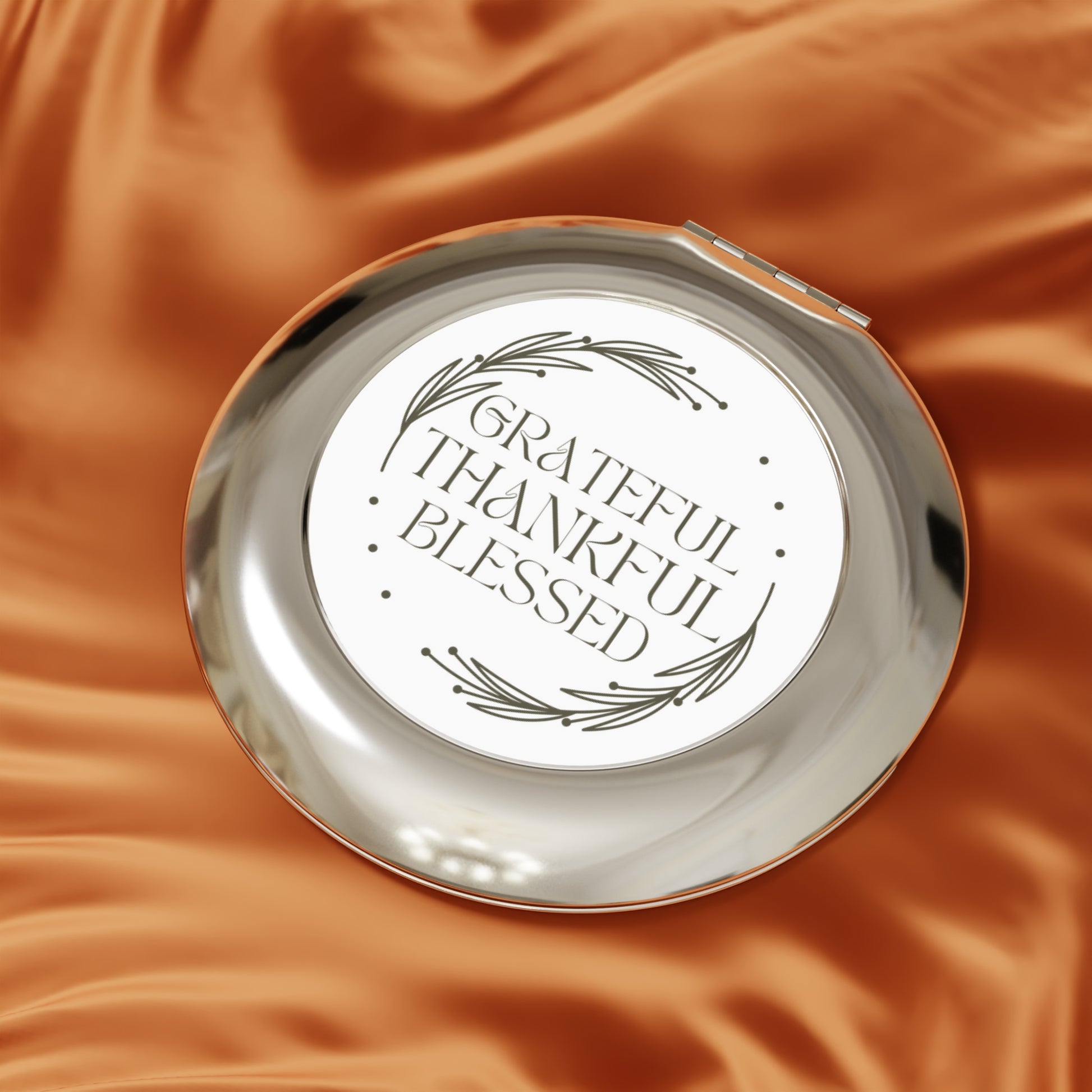 Grateful Thankful Blessed compact mirror with elegant design on a smooth surface