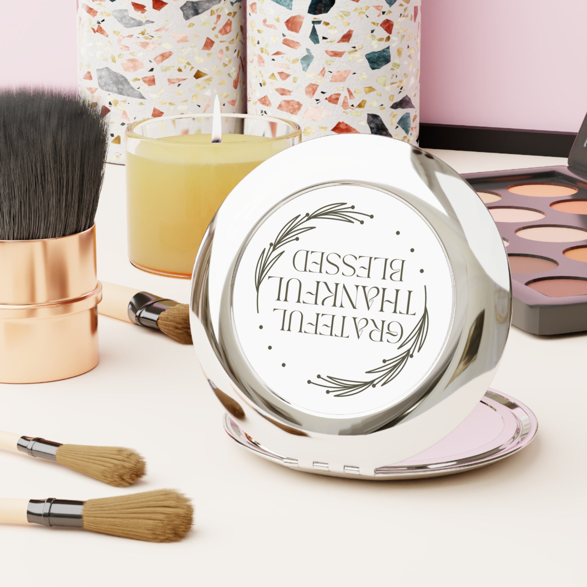 Grateful Thankful Blessed compact mirror on a vanity with makeup brushes and candles