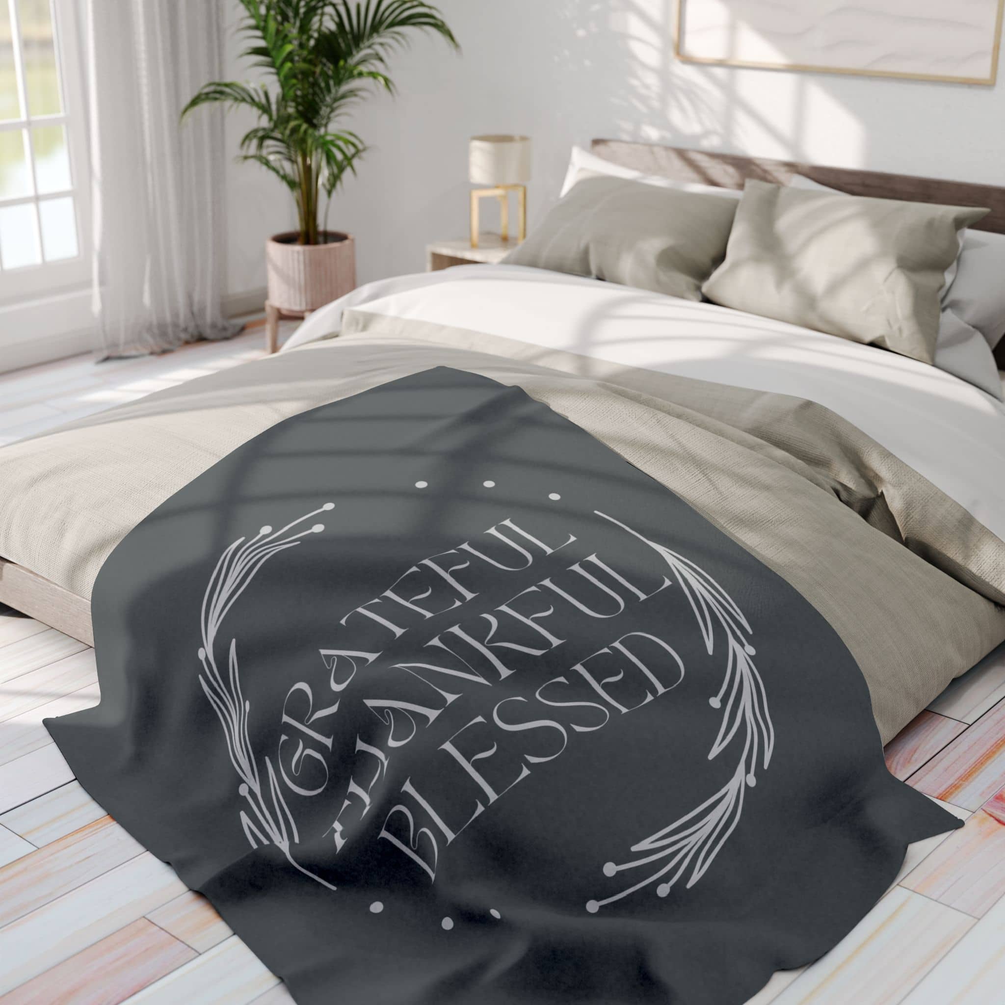 Cozy Grateful Thankful Blessed throw blanket on a light-colored bed in a bright room