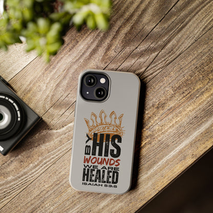 Logos Co. gray scripture phone cover with Isaiah 53:5 Bible verse design on wooden table