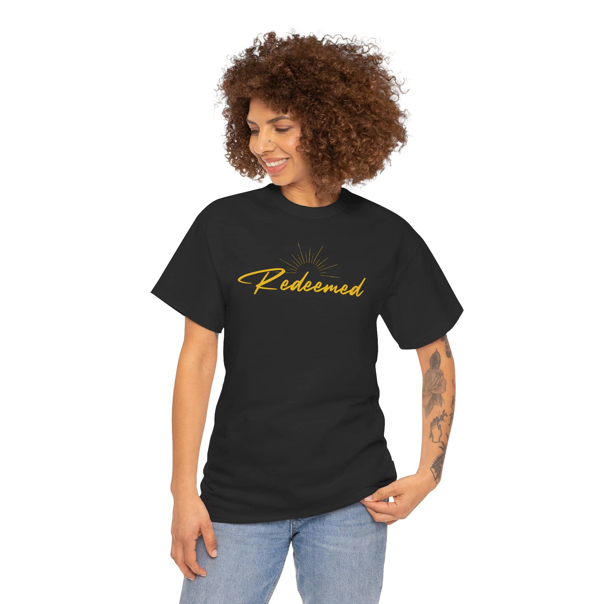Ephesians 1:7 inspirational shirt featuring 'Redeemed' text in elegant gold lettering on black fabric