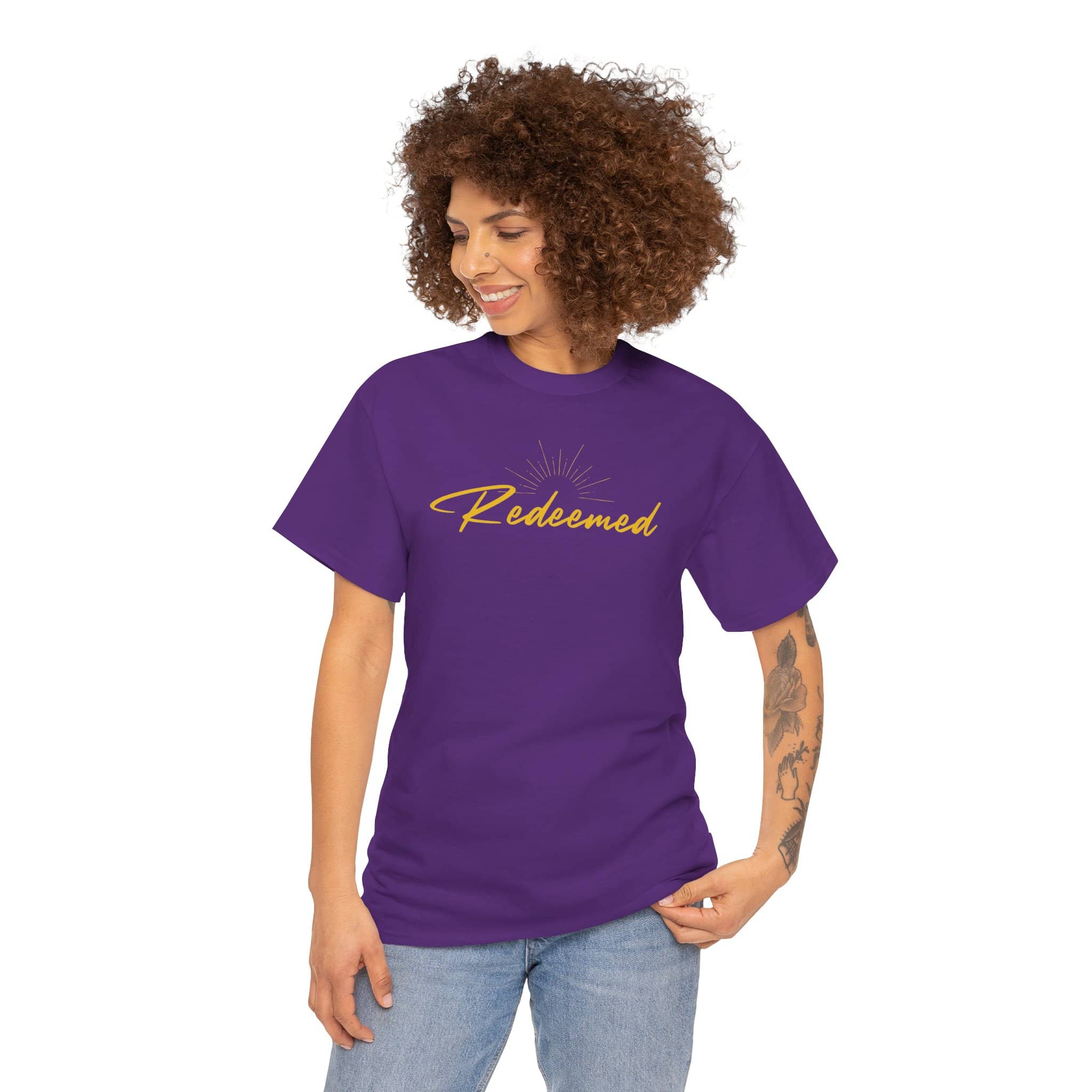 Ephesians 1:7 inspirational shirt featuring the word Redeemed in stylish font on a purple background