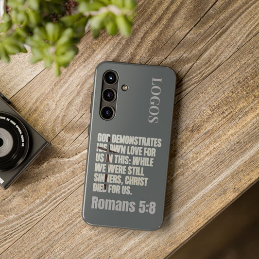 Logos Gray Christian phone case with Romans 5:8 scripture text on dark background