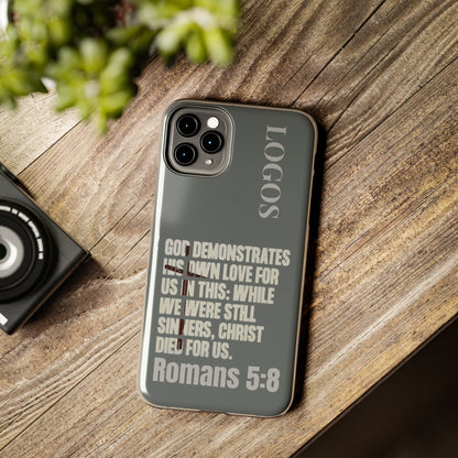 Logos Christian phone case with Romans 5:8 Bible verse design on a gray background