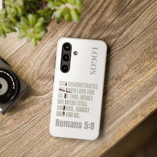 Logos faith-based tough cases white phone case with Romans 5:8 scripture text on wooden surface
