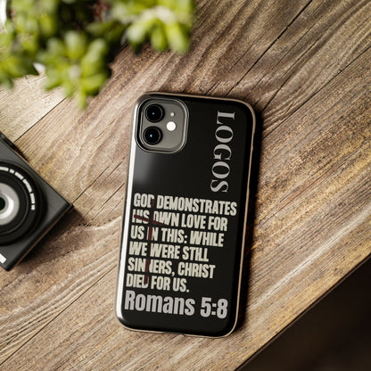 Black Romans 5:8 phone case by Logos featuring inspirational Bible verse design on wooden surface